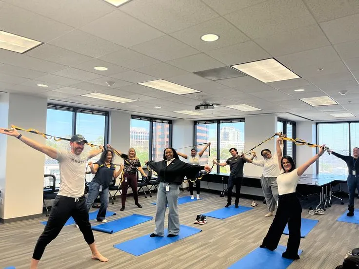 Midday group stretch visible on a shared office display